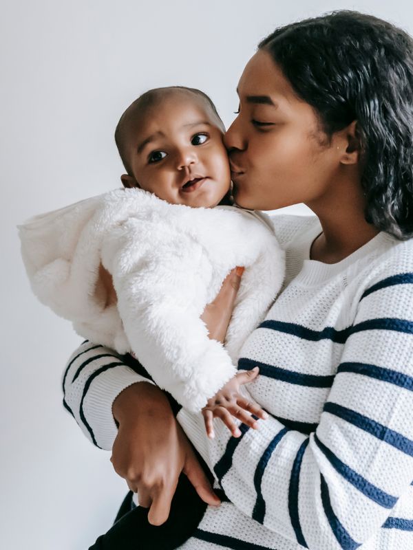mother kissing baby