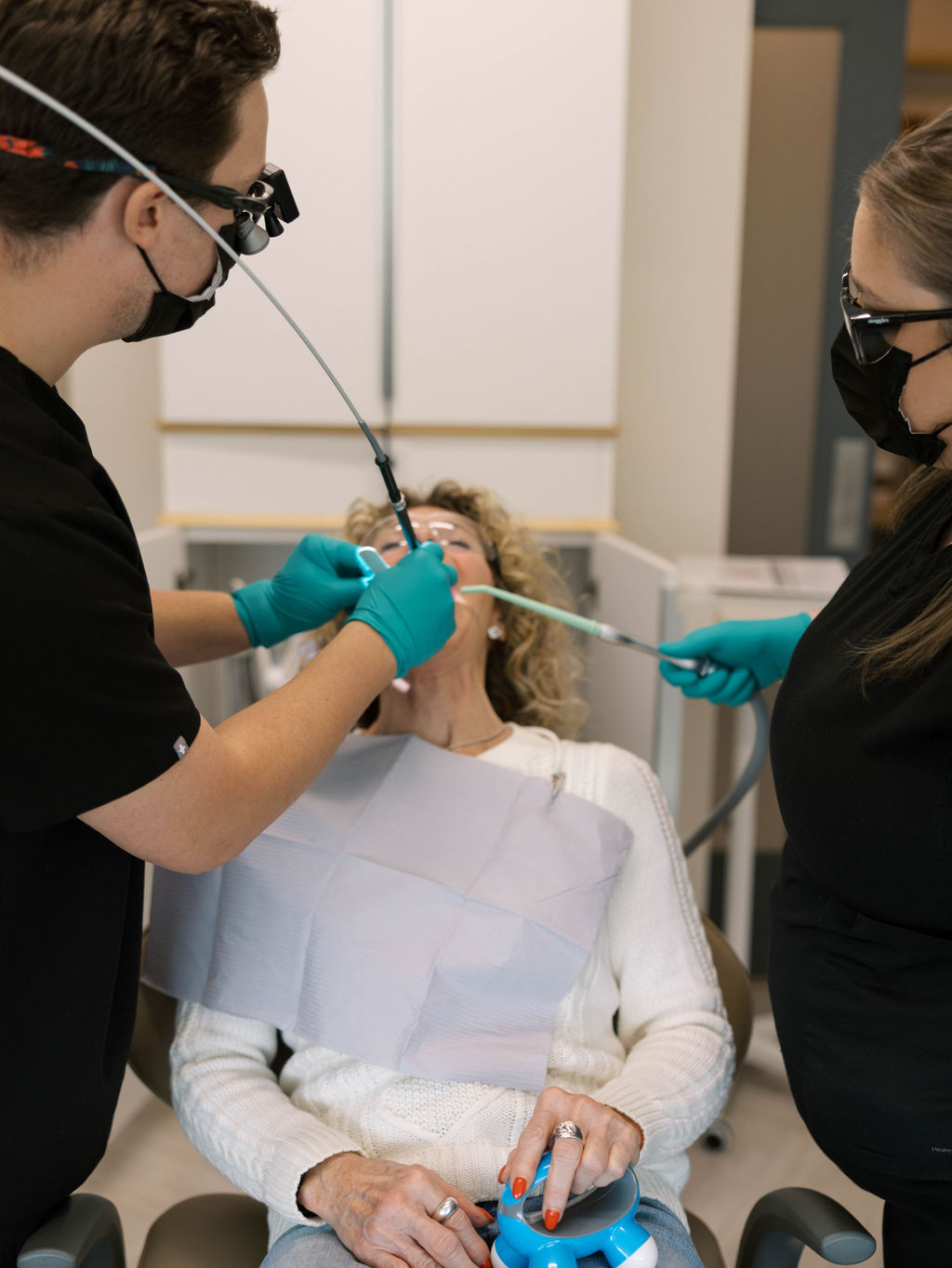 Dentist using laser on patient